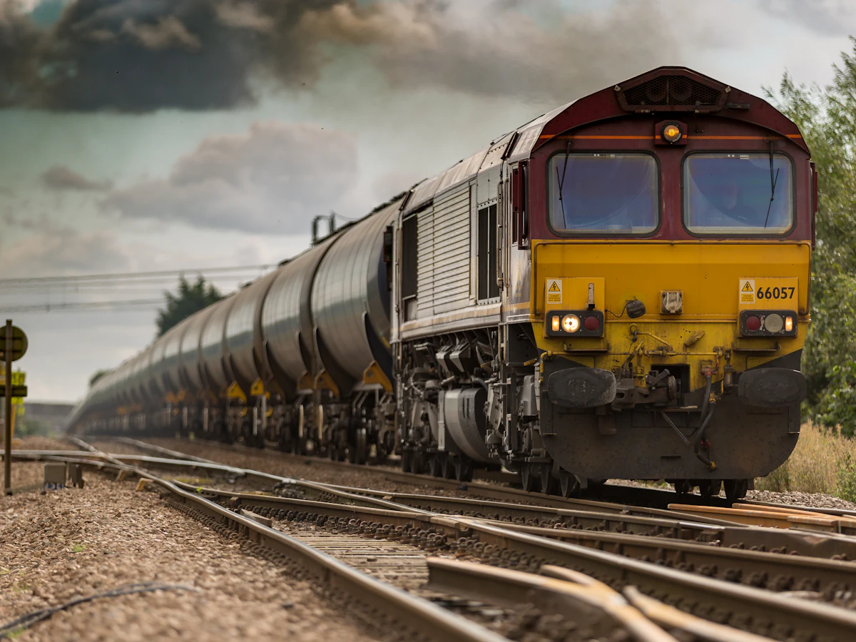 Freight train hauling tank cars down the track
