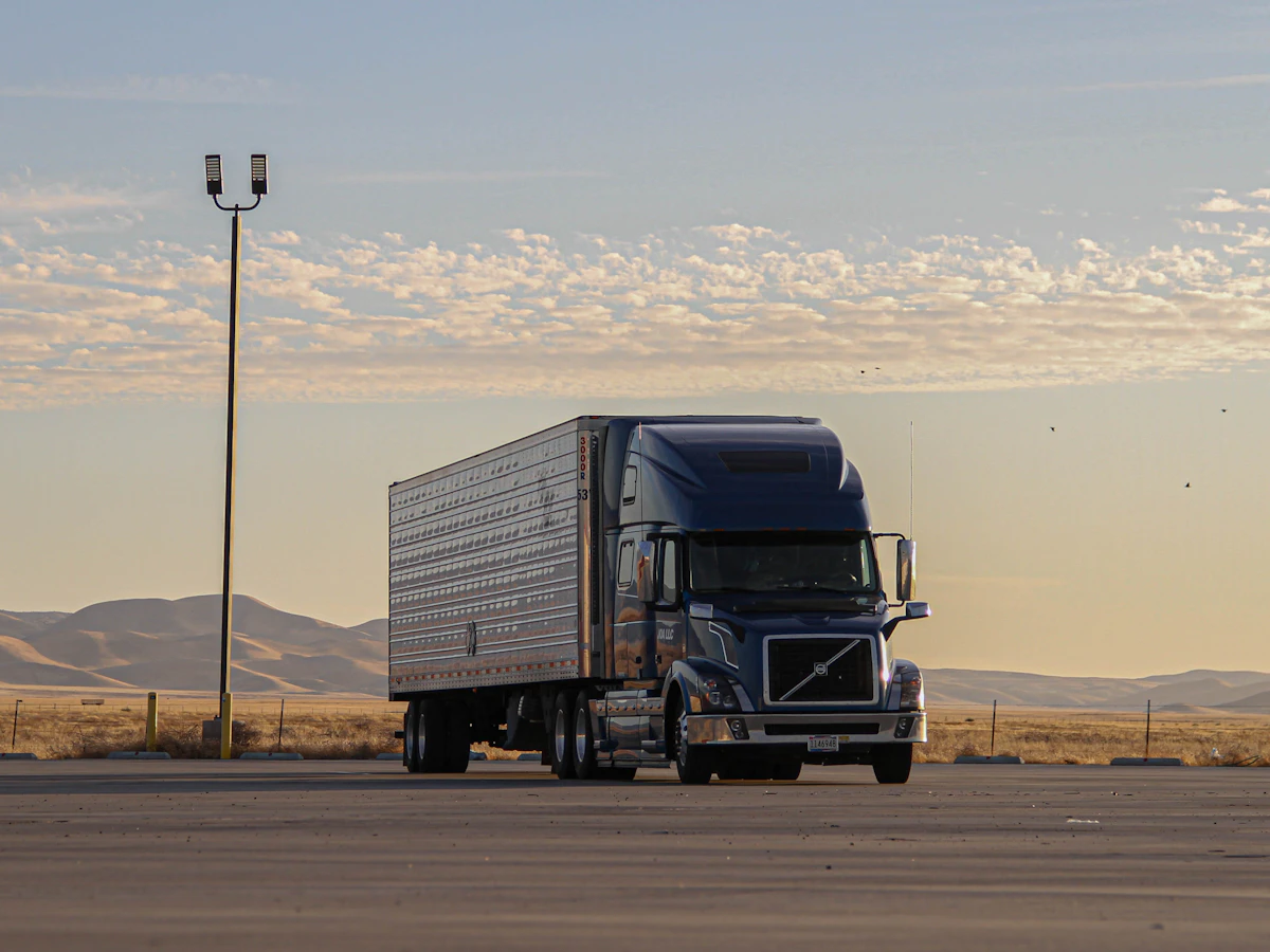 Semi-truck hauling freight on a western highway